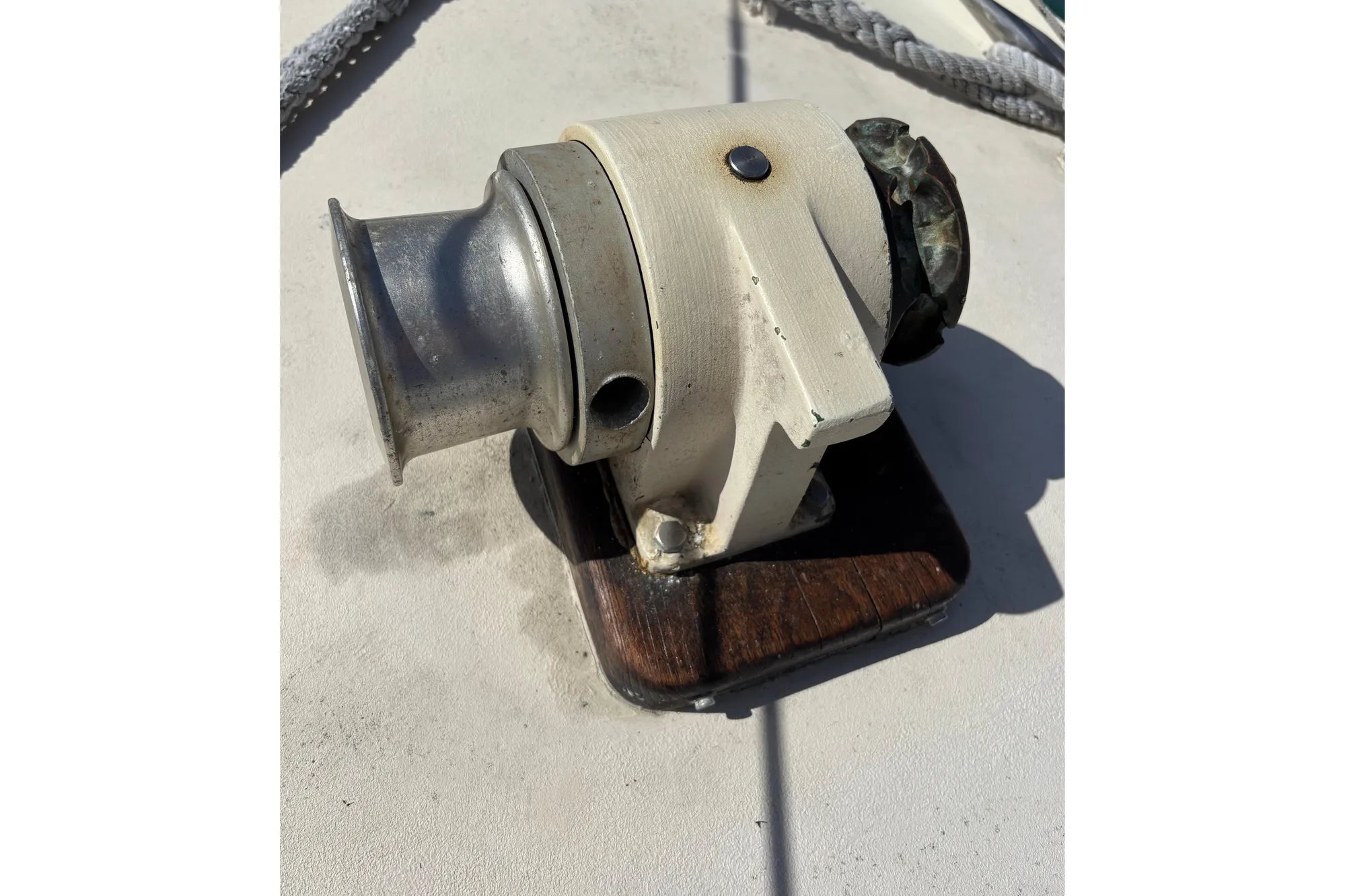Vintage 1968 Spencer 35 boat winch on deck, featuring metal and wood components.