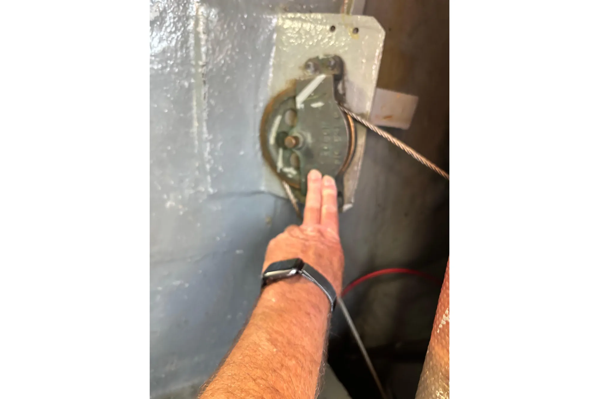 Hand adjusting mechanism on Spencer 35, 1968 model, with visible cable and watch.