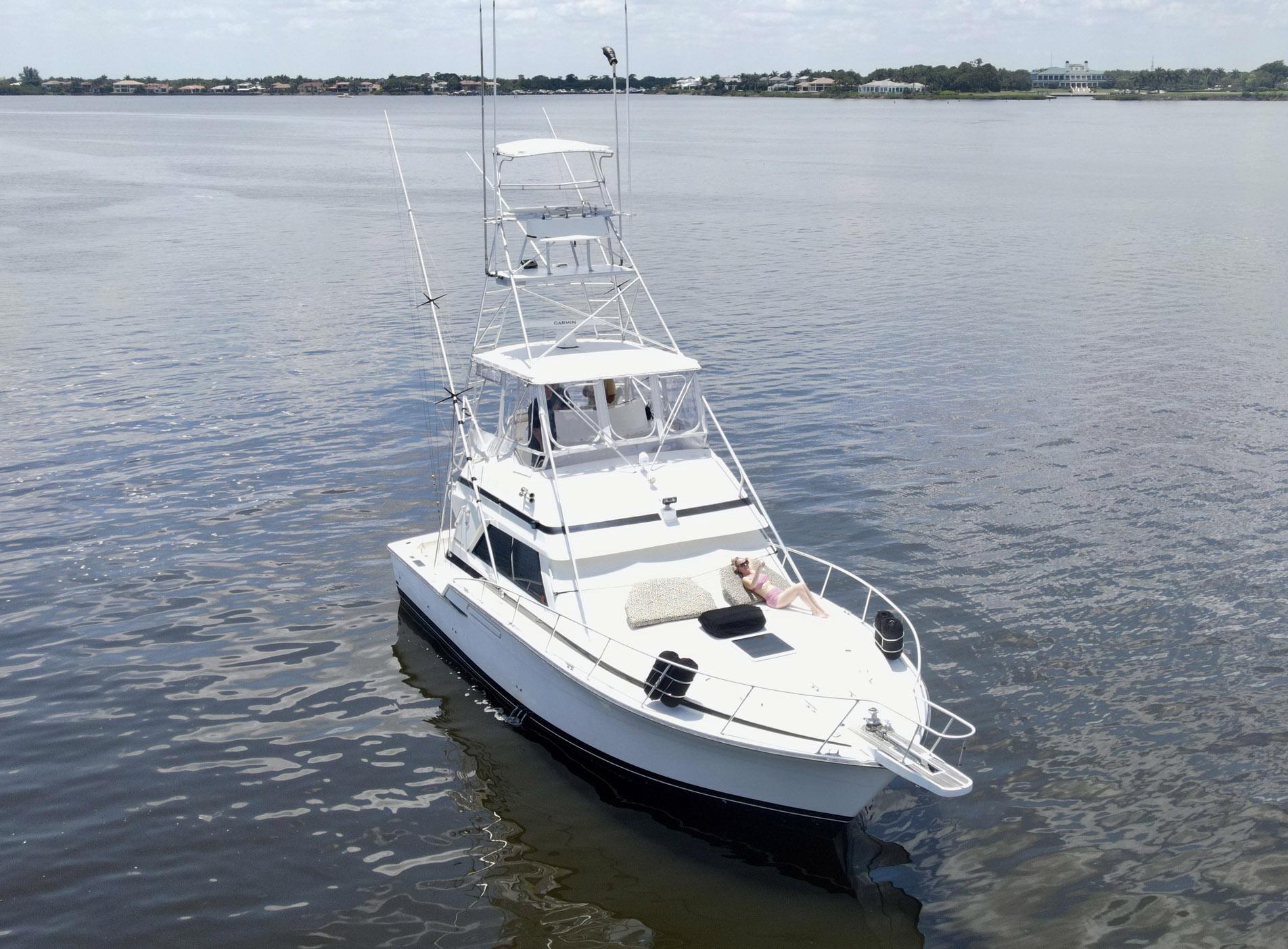 1988 Bertram 43 Convertible yacht on calm water, aerial view.