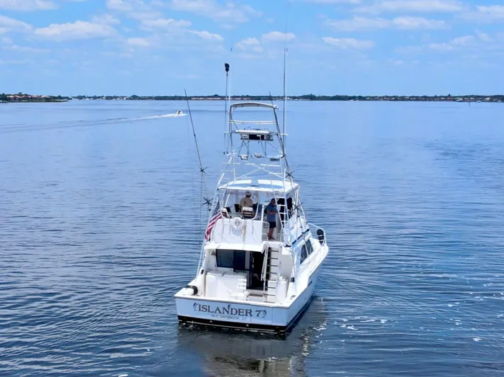 Islander 7 Yacht Photos Pics 1988 Bertram 43 Convertible boat on calm water under blue sky.
