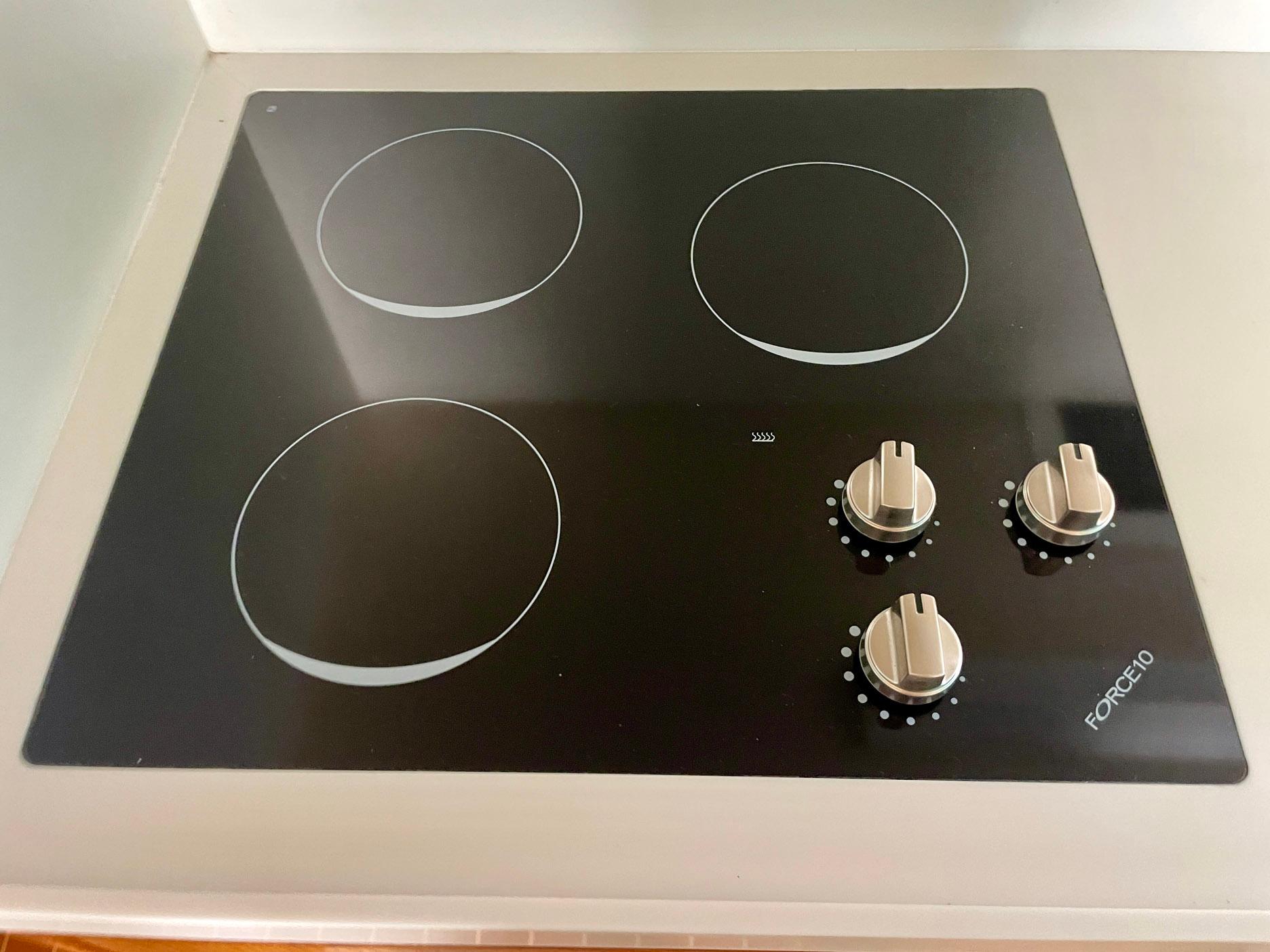 Four-burner electric stove with control knobs on a Bertram 43 Convertible, 1988 model.