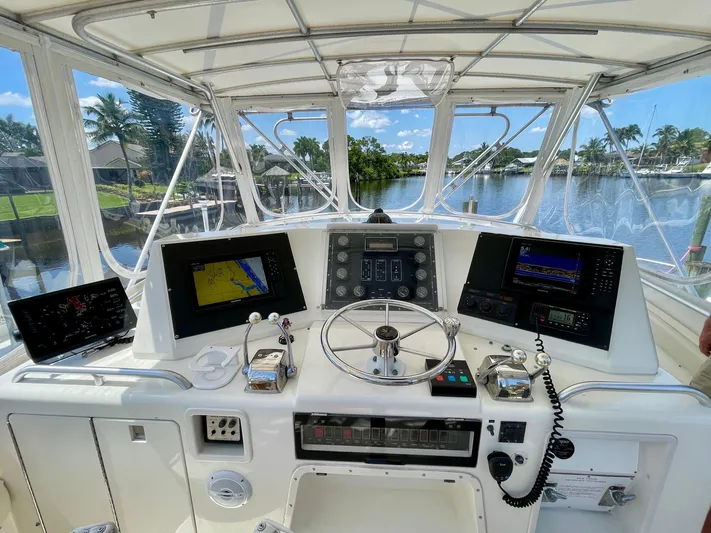 Islander 7 Yacht Photos Pics Helm of 1988 Bertram 43 Convertible yacht with navigation equipment and scenic waterway view.