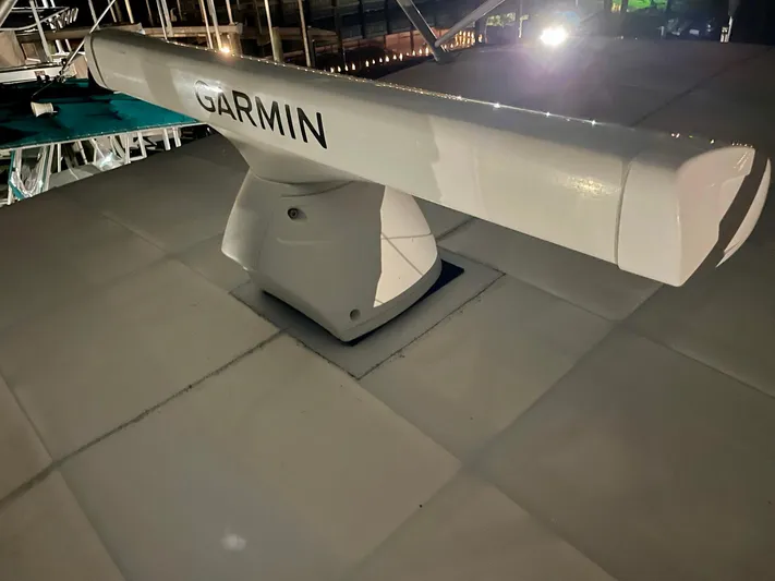 Islander 7 Yacht Photos Pics Garmin radar on 1988 Bertram 43 Convertible boat, illuminated at night.