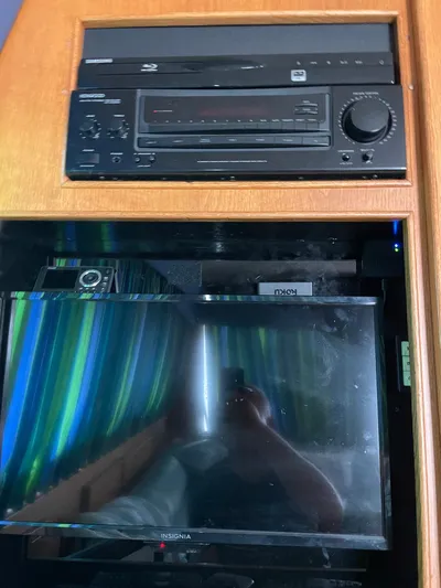 Islander 7 Yacht Photos Pics 1988 Bertram 43 Convertible interior with audio system and Insignia TV.