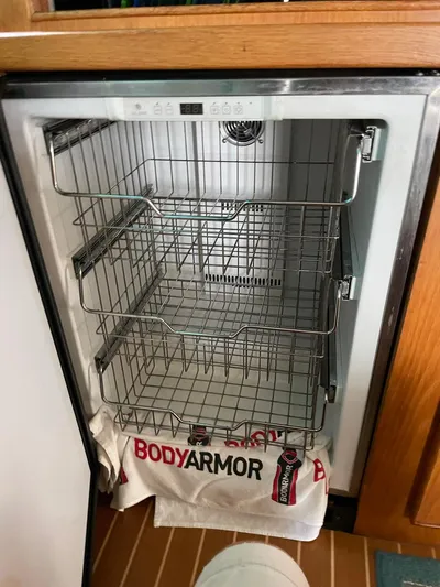 Islander 7 Yacht Photos Pics Empty refrigerator with wire shelves in a 1988 Bertram 43 Convertible boat.