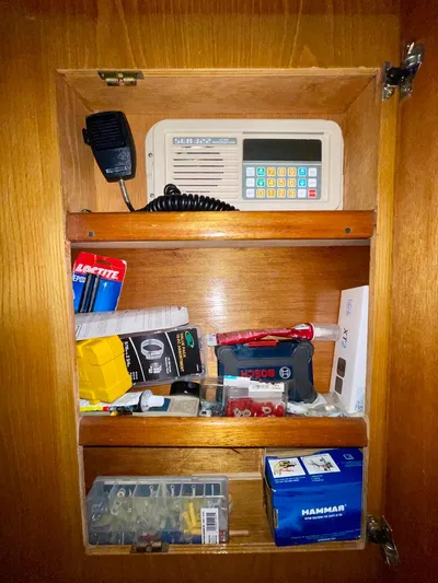 Islander 7 Yacht Photos Pics Wooden cabinet with marine radio and assorted supplies on a 1988 Bertram 43 Convertible.