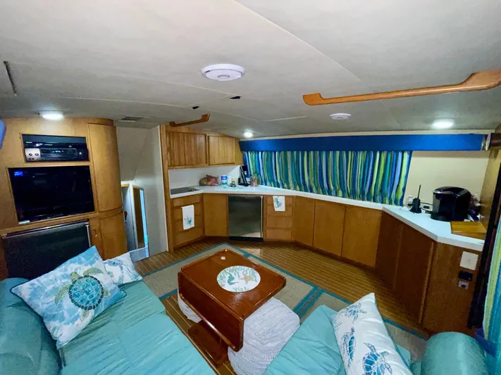 Islander 7 Yacht Photos Pics Interior of 1988 Bertram 43 Convertible yacht with cozy seating and modern kitchen amenities.