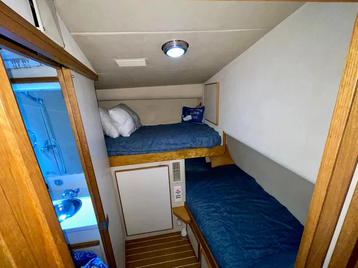 Islander 7 Yacht Photos Pics 1988 Bertram 43 Convertible cabin with bunk beds and compact bathroom.