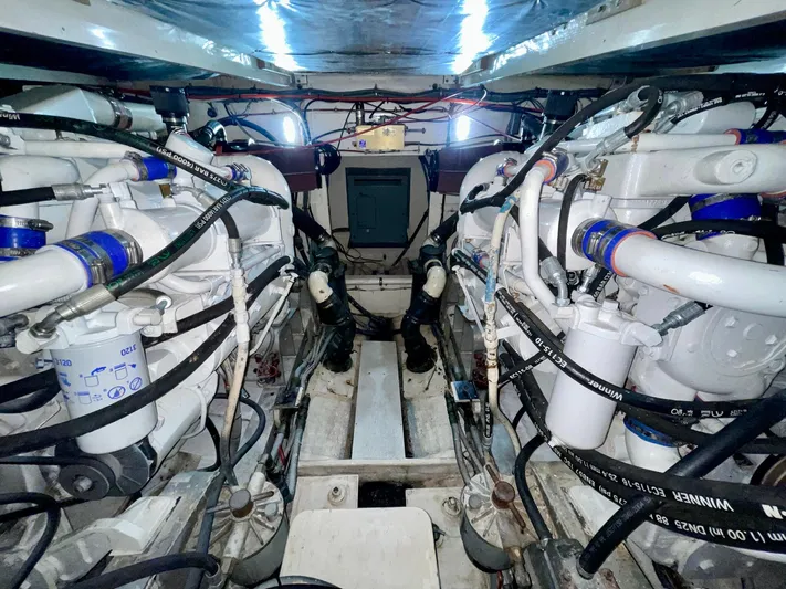 Islander 7 Yacht Photos Pics Engine room of a 1988 Bertram 43 Convertible boat, showcasing dual engines and mechanical components.