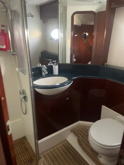 Princess V65 | 65ft | 2004 Yacht Photos Pics Luxurious bathroom in 2004 Princess V65 yacht with modern fixtures and elegant design.