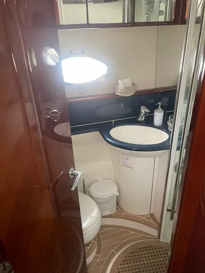 Princess V65 | 65ft | 2004 Yacht Photos Pics Bathroom interior of 2004 Princess V65 yacht with modern fixtures and elegant design.