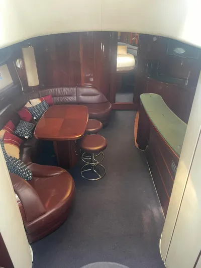 Princess V65 | 65ft | 2004 Yacht Photos Pics Luxurious interior of a 2004 Princess V65 yacht with leather seating and wooden accents.