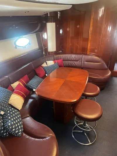 Princess V65 | 65ft | 2004 Yacht Photos Pics Luxurious 2004 Princess V65 yacht interior with leather seating and wooden table.