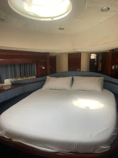 Princess V65 | 65ft | 2004 Yacht Photos Pics Luxurious cabin interior of 2004 Princess V65 yacht with a spacious bed.