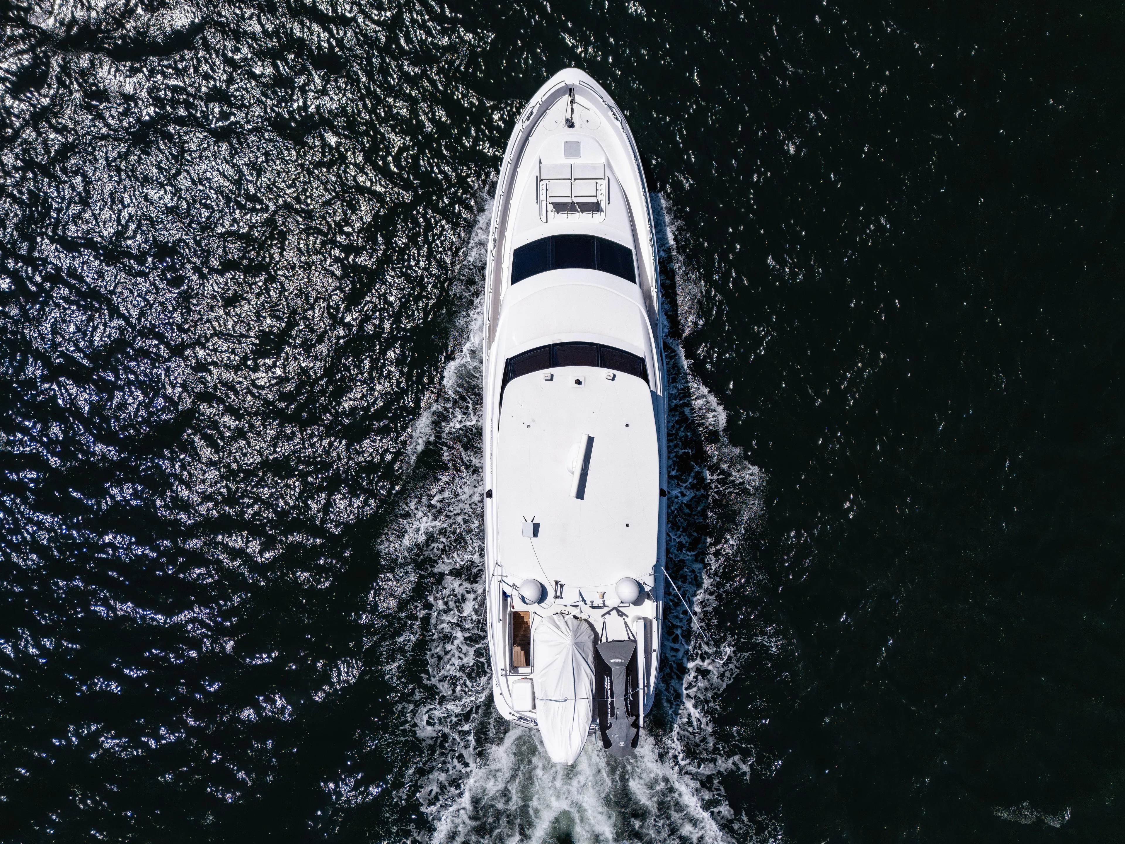Miss Sealaneous Expense II Yacht Photos Pics Aerial view of 2008 Hatteras 72 Motor Yacht cruising on dark water.