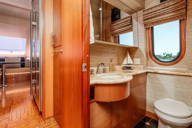 Miss Sealaneous Expense II Yacht Photos Pics Luxurious bathroom interior of 2008 Hatteras 72 Motor Yacht with wood accents and ocean view.