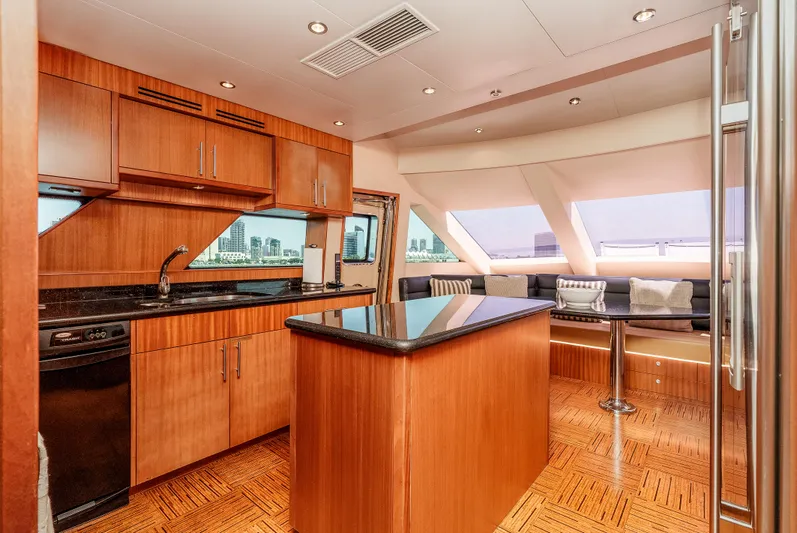 Miss Sealaneous Expense II Yacht Photos Pics Luxurious kitchen interior of 2008 Hatteras 72 Motor Yacht with wood cabinetry and modern appliances.