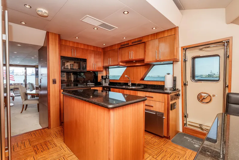 Miss Sealaneous Expense II Yacht Photos Pics Luxurious kitchen interior of 2008 Hatteras 72 Motor Yacht with wood cabinetry and modern appliances.