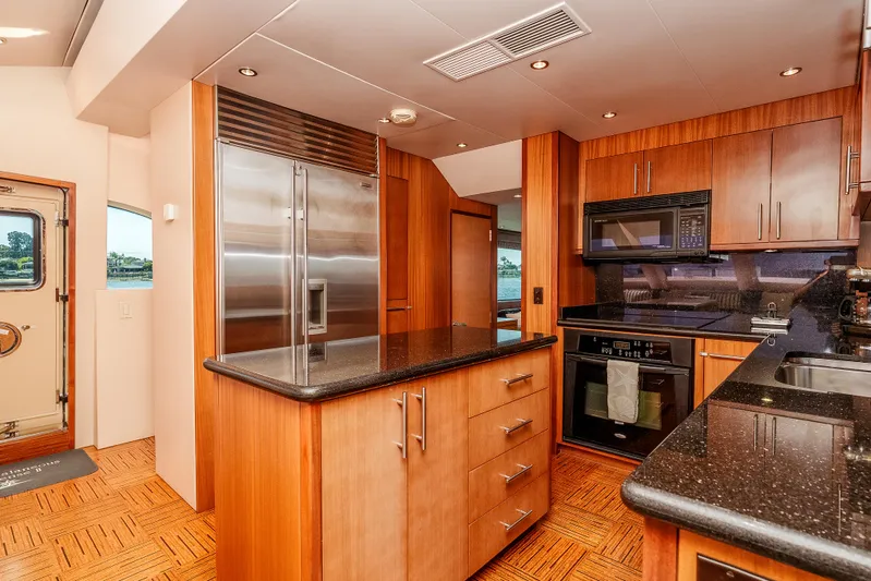 Miss Sealaneous Expense II Yacht Photos Pics Luxurious kitchen interior of 2008 Hatteras 72 Motor Yacht with modern appliances and wood cabinetry.