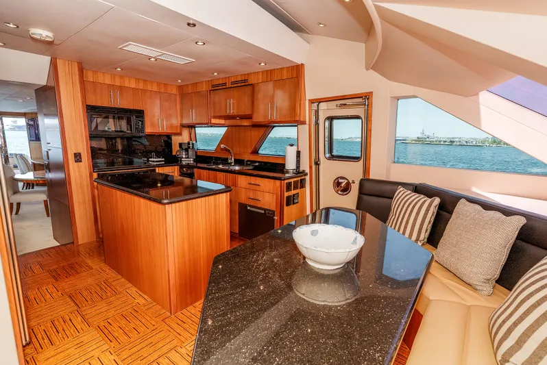 Miss Sealaneous Expense II Yacht Photos Pics Luxurious kitchen and dining area inside a 2008 Hatteras 72 Motor Yacht.