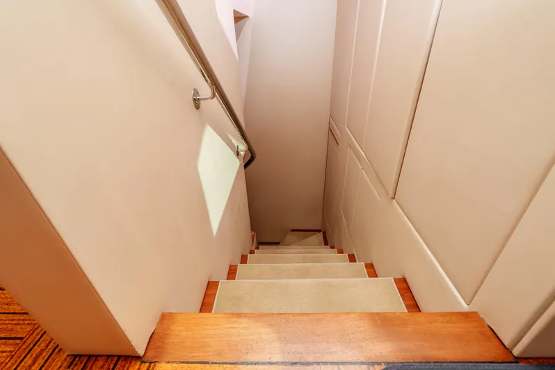 Miss Sealaneous Expense II Yacht Photos Pics Staircase inside 2008 Hatteras 72 Motor Yacht with wooden steps and handrail.