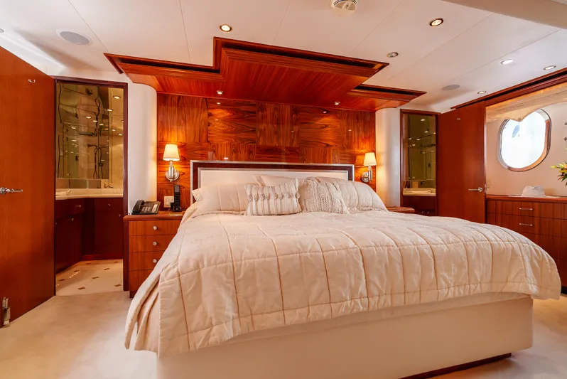 Miss Sealaneous Expense II Yacht Photos Pics Luxurious bedroom in 2008 Hatteras 72 Motor Yacht with elegant wood paneling.