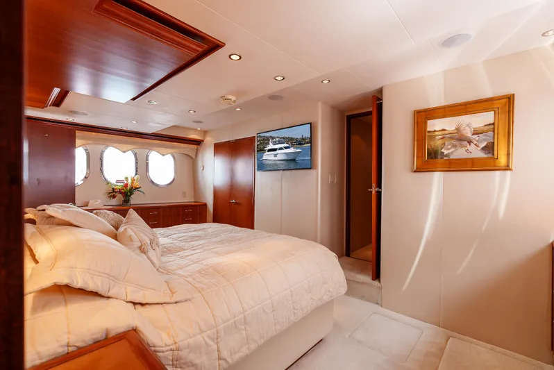 Miss Sealaneous Expense II Yacht Photos Pics Luxurious bedroom interior of 2008 Hatteras 72 Motor Yacht with elegant decor and natural light.