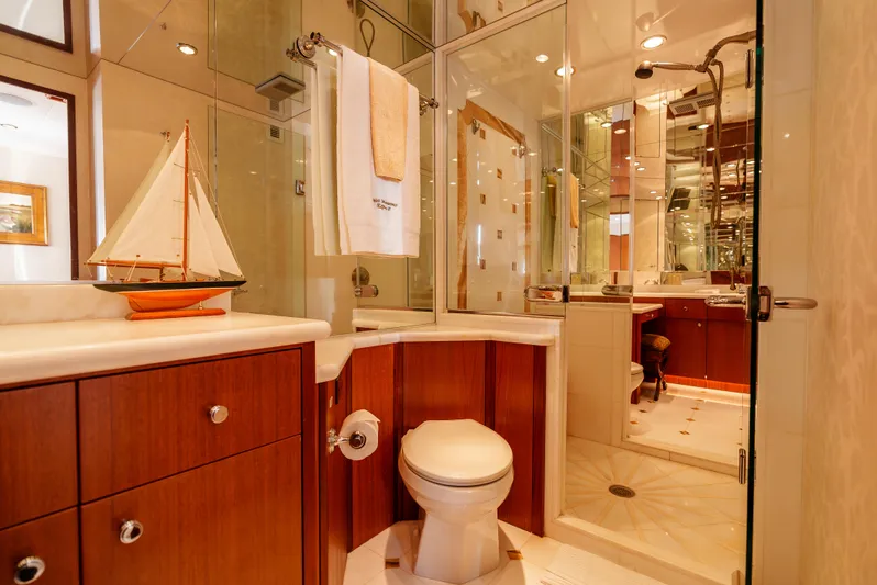 Miss Sealaneous Expense II Yacht Photos Pics Luxurious bathroom on 2008 Hatteras 72 Motor Yacht with elegant wood cabinetry and glass shower.