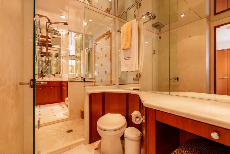 Miss Sealaneous Expense II Yacht Photos Pics Luxurious bathroom in a 2008 Hatteras 72 Motor Yacht with elegant wood and glass accents.