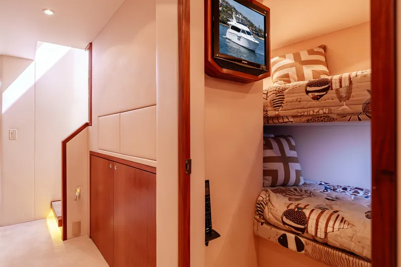 Miss Sealaneous Expense II Yacht Photos Pics Interior of 2008 Hatteras 72 Motor Yacht with cozy bunk beds and wooden cabinetry.