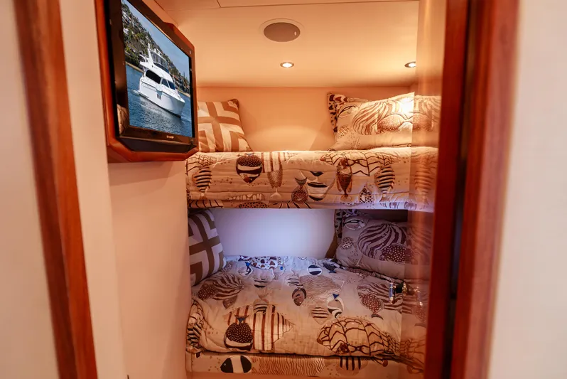 Miss Sealaneous Expense II Yacht Photos Pics Bunk beds in 2008 Hatteras 72 Motor Yacht cabin with patterned bedding and wall art.