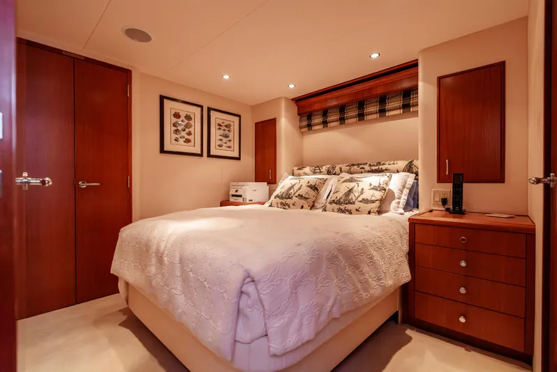 Miss Sealaneous Expense II Yacht Photos Pics Luxurious bedroom interior of 2008 Hatteras 72 Motor Yacht with elegant decor and cozy bedding.