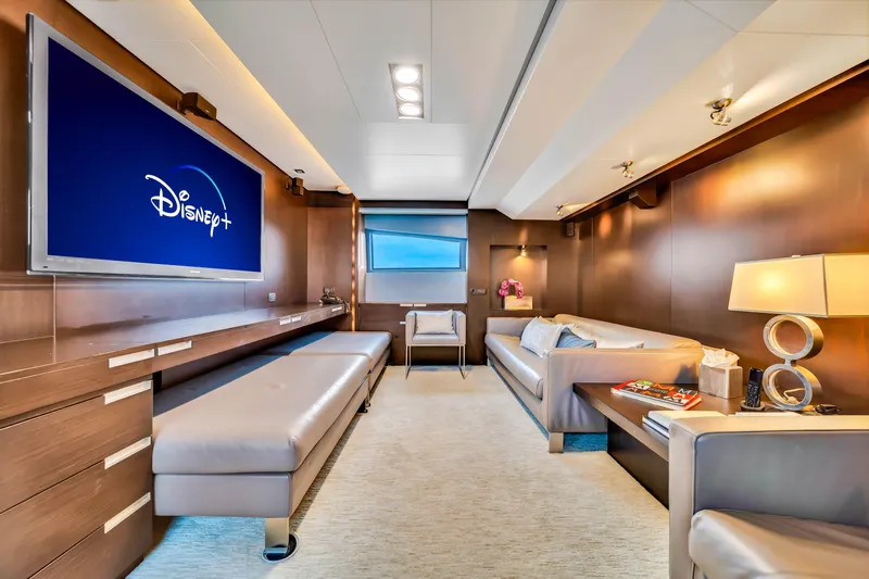  Yacht Photos Pics Luxurious interior of 2012 Azimut 116 yacht with modern seating and large TV displaying Disney+.