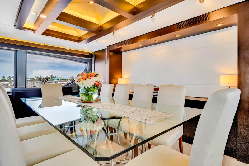  Yacht Photos Pics Luxurious dining area on 2012 Azimut 116 yacht with elegant glass table and white chairs.