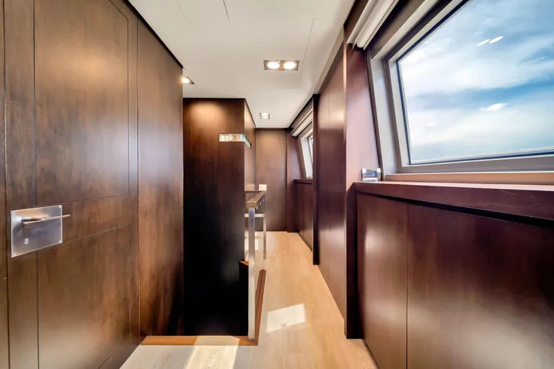  Yacht Photos Pics Luxurious interior hallway of 2012 Azimut 116 yacht with wooden paneling and large windows.