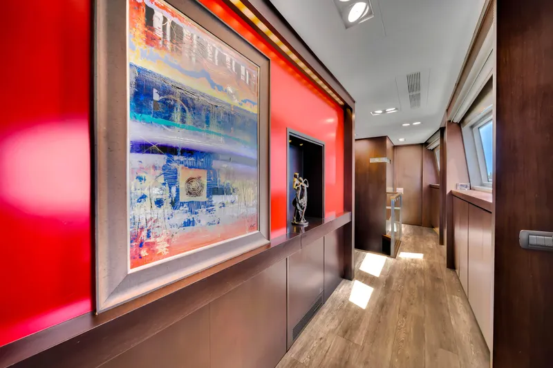  Yacht Photos Pics Luxurious hallway in 2012 Azimut 116 yacht with vibrant artwork and wooden flooring.