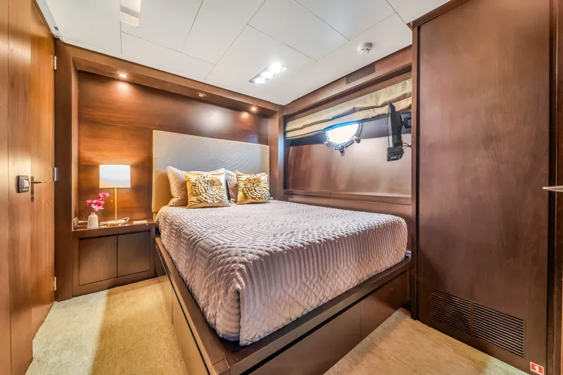  Yacht Photos Pics Luxurious bedroom interior on 2012 Azimut 116 yacht, featuring elegant wood finishes and cozy bedding.