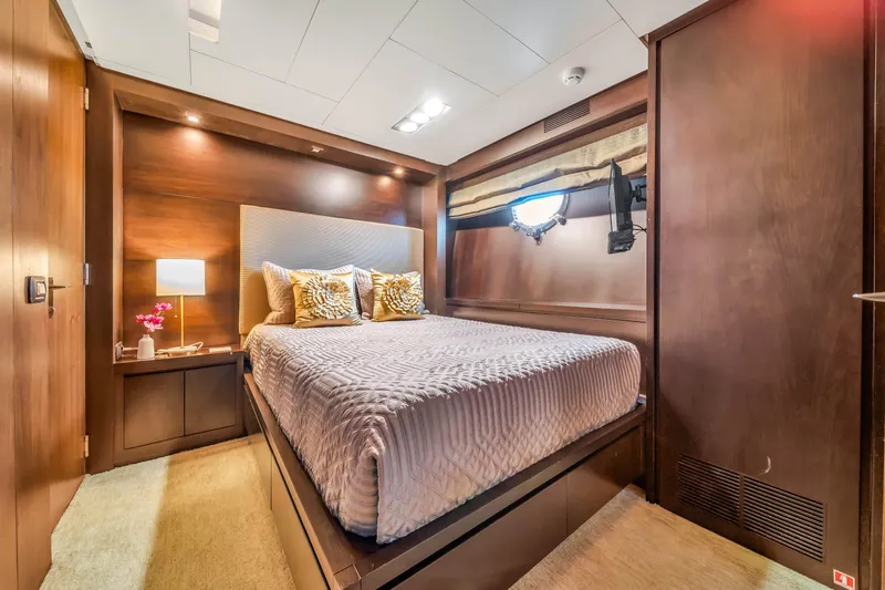  Yacht Photos Pics Luxurious bedroom interior of 2012 Azimut 116 yacht with elegant wood finishes.