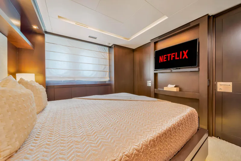  Yacht Photos Pics Luxurious bedroom on 2012 Azimut 116 yacht with TV displaying Netflix.