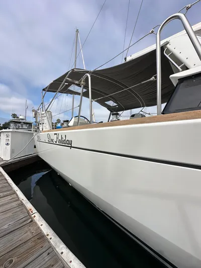 Doc Holiday Yacht Photos Pics 2012 Beneteau Sense 43 yacht docked, featuring sleek design and canopy.