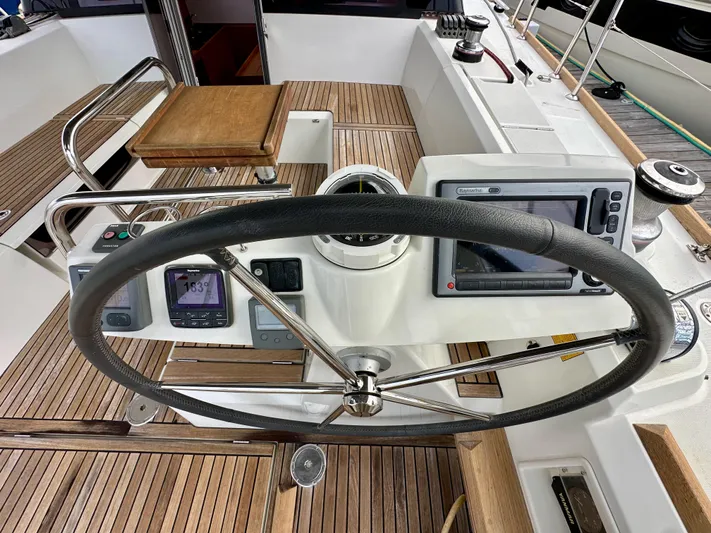 Doc Holiday Yacht Photos Pics Steering wheel and navigation instruments on 2012 Beneteau Sense 43 yacht deck.
