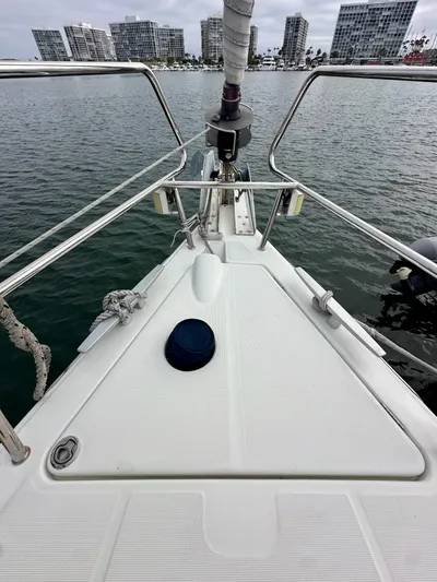 Doc Holiday Yacht Photos Pics Bow of 2012 Beneteau Sense 43 yacht with city skyline in background.