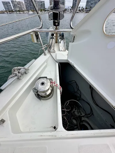 Doc Holiday Yacht Photos Pics Beneteau Sense 43 sailboat deck with open storage compartment, winch, and marina view.