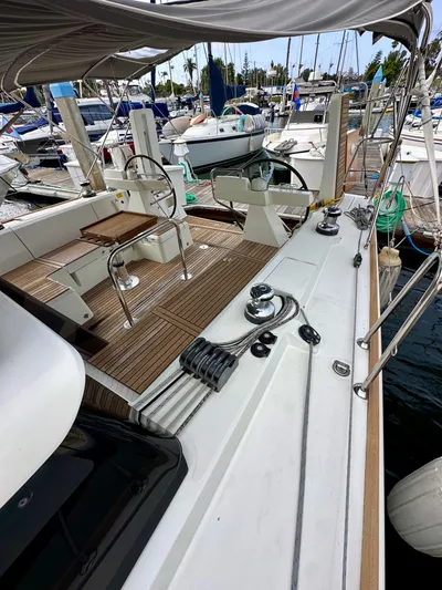 Doc Holiday Yacht Photos Pics 2012 Beneteau Sense 43 sailboat with teak deck and dual steering wheels in a marina.