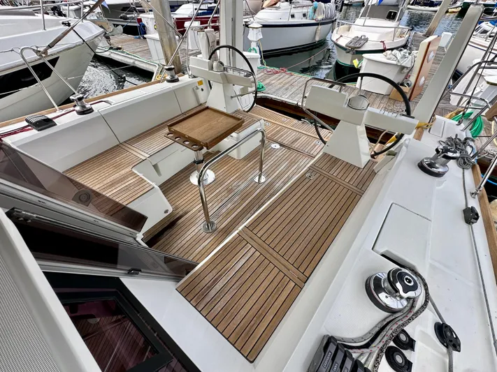 Doc Holiday Yacht Photos Pics 2012 Beneteau Sense 43 yacht cockpit with wooden deck and steering wheel at marina.