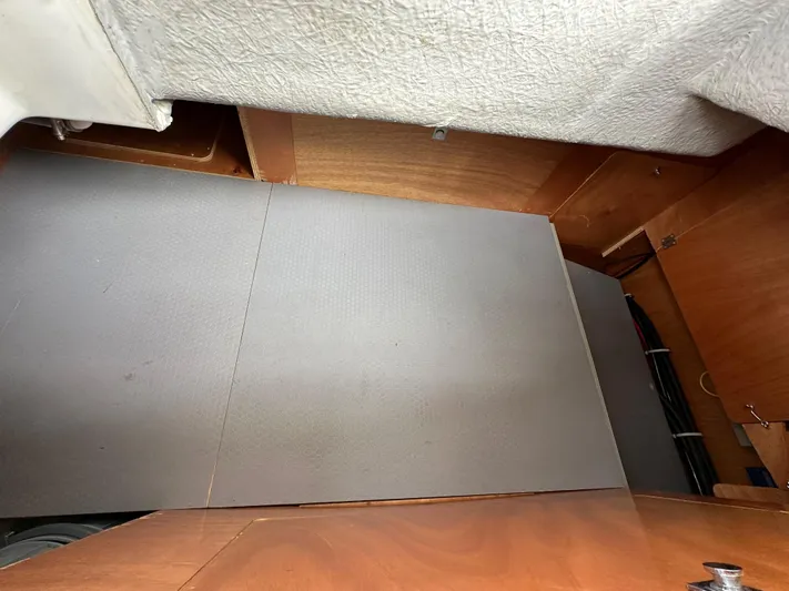 Doc Holiday Yacht Photos Pics Interior view of a 2012 Beneteau Sense 43 yacht, showcasing wooden cabinetry and flooring.