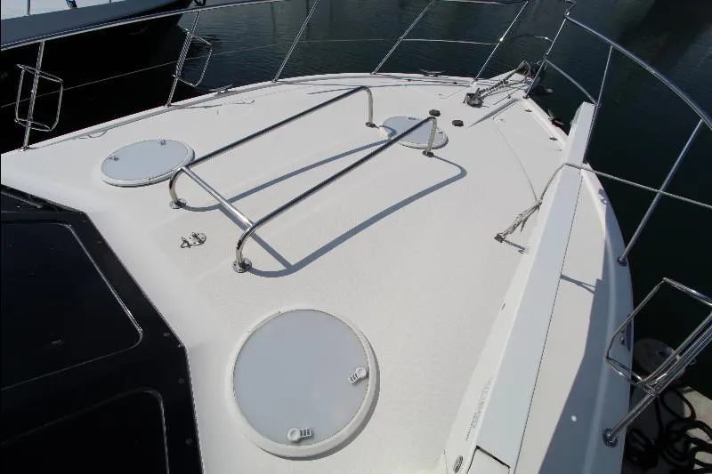  Yacht Photos Pics 2005 Riviera 46 Convertible Sportfisher boat deck with railings and hatches.