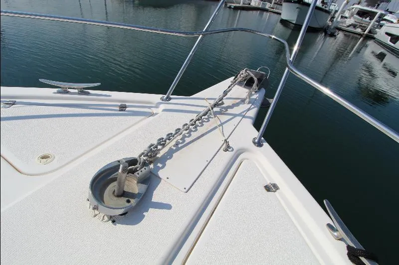  Yacht Photos Pics Bow of 2005 Riviera 46 Convertible Sportfisher with anchor chain in marina.