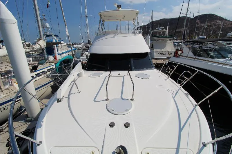  Yacht Photos Pics 2005 Riviera 46 Convertible Sportfisher docked at marina, front view.