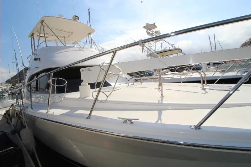  Yacht Photos Pics 2005 Riviera 46 Convertible Sportfisher yacht docked, showcasing sleek design and polished railings.